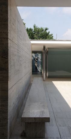 a concrete bench sitting in front of a building