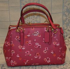 Coach Mini Christie Carryall Wildflower Dahlia Multi Pink Purse Handbag NWT New Welcome!  Here you will find a New With Tags, Coach Mini Christie Carryall Wildflower Dahlia Multi pink Purse / handbag / crossbody.  This was bought new at the Coach outlet store and was never used.   Color: Dahlia Multi Wildflower Beautiful COACH Mini Christie carryall in wildflower dahlia. Fun bag for all seasons! Very stylish bag with 2 zipper compartments and snap closure. fabric lining Handle with 5 3/4" drop T Girly Bracelets, Luggage Backpack, Coach Outlet, Girly Accessories, Pink Purse, Pretty Bags, Purse Styles, Cute Stationery, Cute Bags