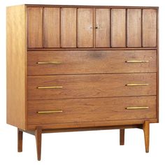 a wooden dresser with brass handles and drawers