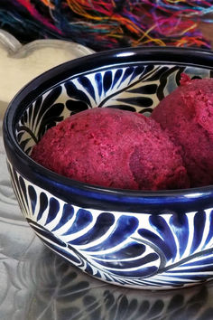 two balls of red velvet in a blue and white bowl