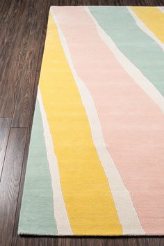 a rug on the floor with wooden floors in front of it and a wood floor