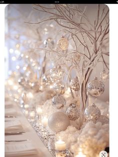 the table is decorated with silver and white ornaments