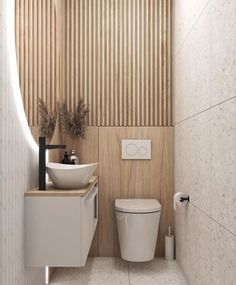 a white toilet sitting next to a sink under a bathroom faucet on top of a wooden paneled wall