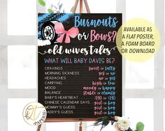 a baby shower sign hanging on the wall next to a vase with flowers in it