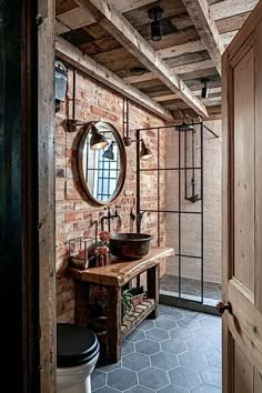 a bathroom with brick walls and exposed ceiling