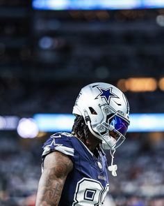 a football player wearing a white and blue uniform