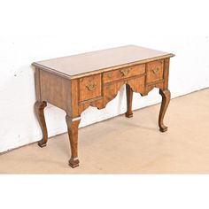 an old wooden desk with two drawers on one side and a drawer on the other