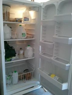 an open refrigerator with milk, yogurt and other items in the door area