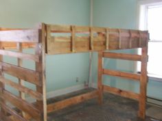 a bunk bed with wooden slats in an empty room