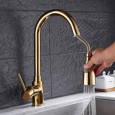 a person is washing their hands under a faucet in a sink with water running from the faucet