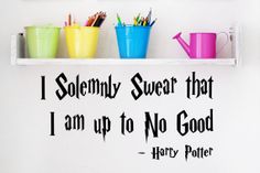 harry potter quote wall decal with cups and pencils on the shelf next to it