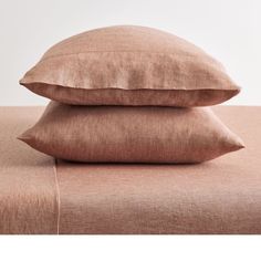 two pillows are stacked on top of each other