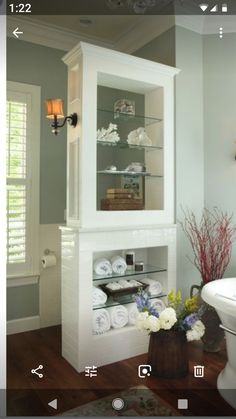 a bathroom with a chandelier, toilet and sink