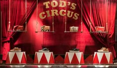 red and white circus themed display with top's crocs written on the wall