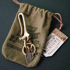 a pair of scissors sitting on top of a green bag next to a small tag