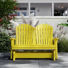 a yellow bench sitting in front of a white house