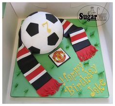 a birthday cake with a soccer ball and scarf