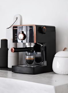 an espresso machine sitting on top of a counter