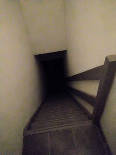 an empty hallway with stairs leading up to the ceiling