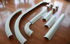 several pieces of white plastic sitting on top of a wooden floor