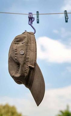 an old hat hanging on a clothes line with some wires in the air above it