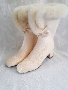 a pair of white boots with lace and fur lined up on top of each other