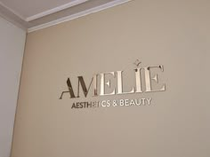 the name amelie aesthetics and beauty is displayed on a wall