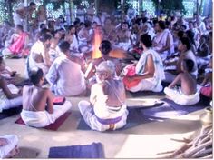 many people are sitting on the ground in meditation