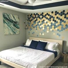 a bed sitting in a bedroom next to a wall with circles painted on the walls