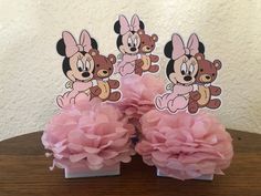 two pink tissue pom poms with minnie mouse on them sitting next to each other