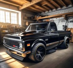 an old black pickup truck parked in a garage