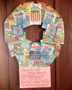 a wreath made out of magazine pages on a wooden wall with a price tag attached to it