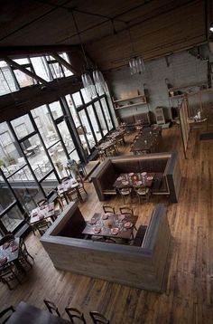 an overhead view of a restaurant with wooden floors and tables set up for two people