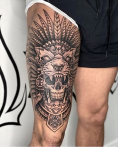 a man's leg with a tattoo on it and a skull in the middle