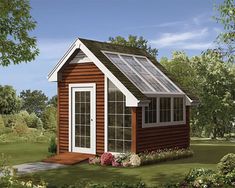 a small wooden shed with a white door and windows