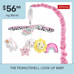 a pink baby crib with stuffed animals hanging from it's sides and the words, the peanutshell look up baby