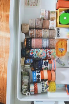 an open refrigerator filled with lots of different types of tape