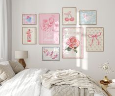 a white bedroom with pink and blue art on the wall