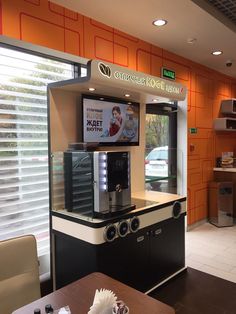 the interior of a fast food restaurant with orange walls and white trim on the windows