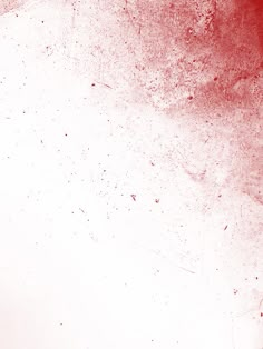 an abstract red and white background with some paint splattered on the wall,