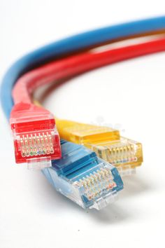 two red, yellow and blue cables connected to each other on a white background royalty images