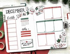 a christmas planner spread on top of a red and green desk with some decorations around it