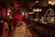 a dimly lit bar with lots of bottles