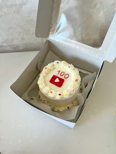 a cupcake in a box with the number 100 on it