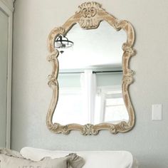 a mirror on the wall above a couch