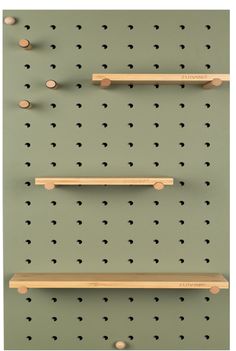 three wooden shelves are mounted to the wall with pegs on each shelf and one is empty