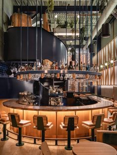 the interior of a restaurant with wooden tables and stools