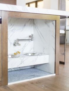 a bathroom with marbled walls and wooden floors