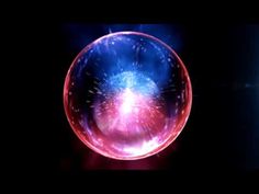 an image of fireworks in a glass ball on black background with red and blue colors