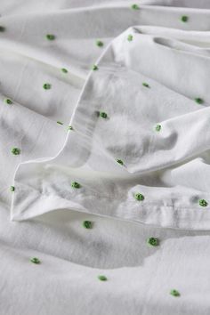 the white sheets have green spots on them